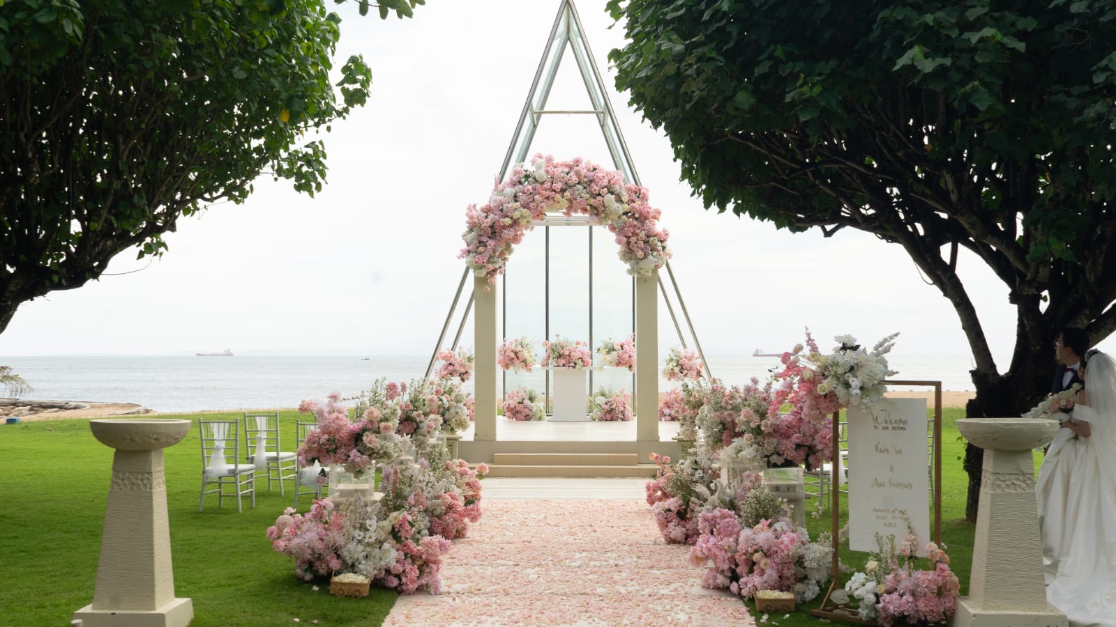 Coastal wedding chapel with blush florals and a petal-lined aisle